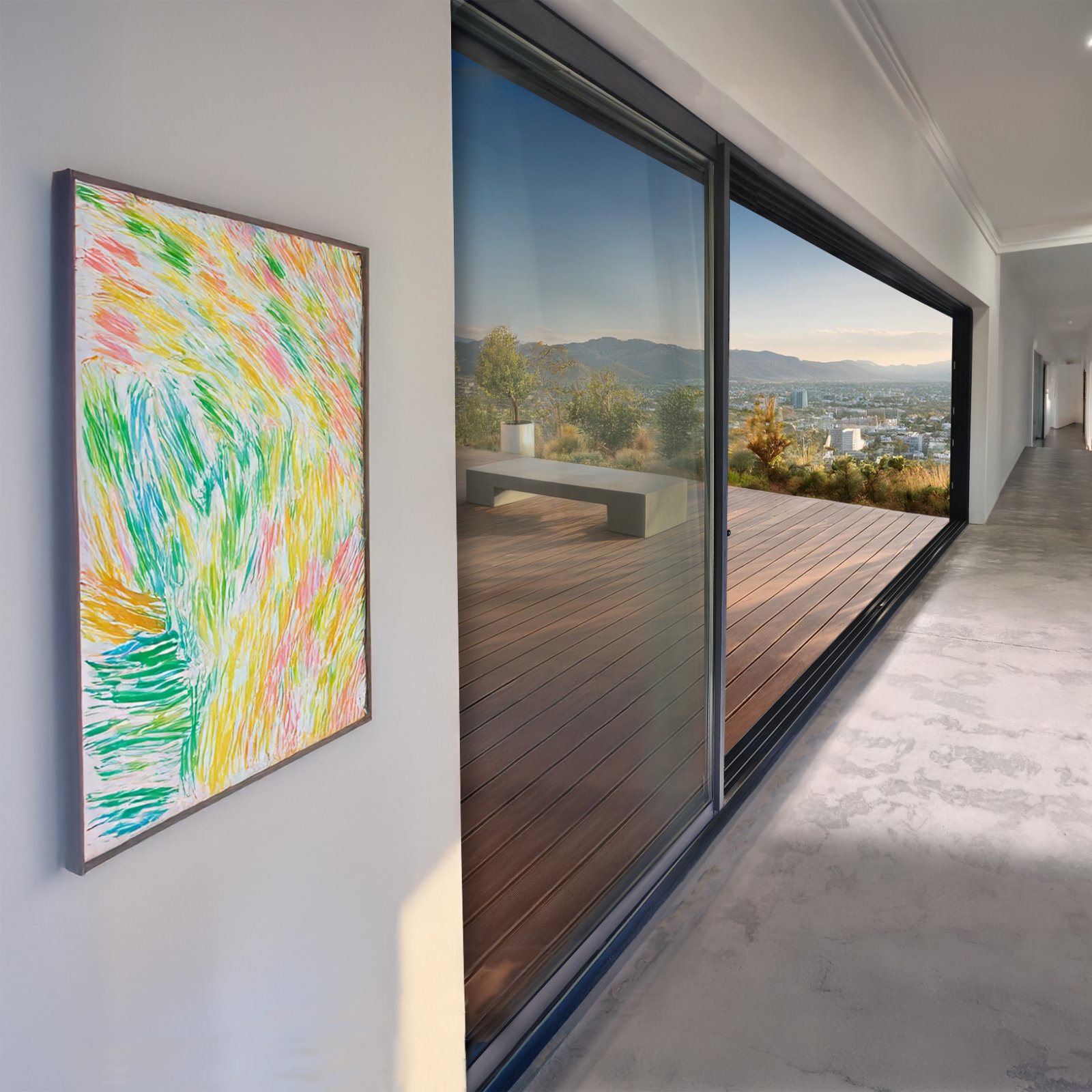 ENNION aluminum multi-slide door half open onto a deck with a city view